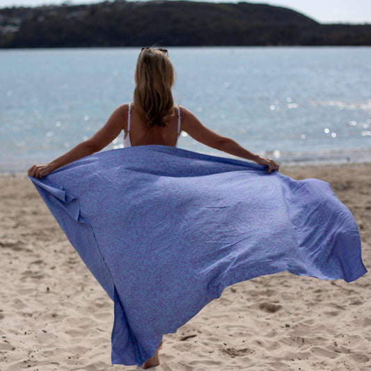 Day spa luxe sarong beachwear look, photographed outdoors in natural light