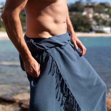 Char blue men beach sarong beachwear look, photographed outdoors in natural light