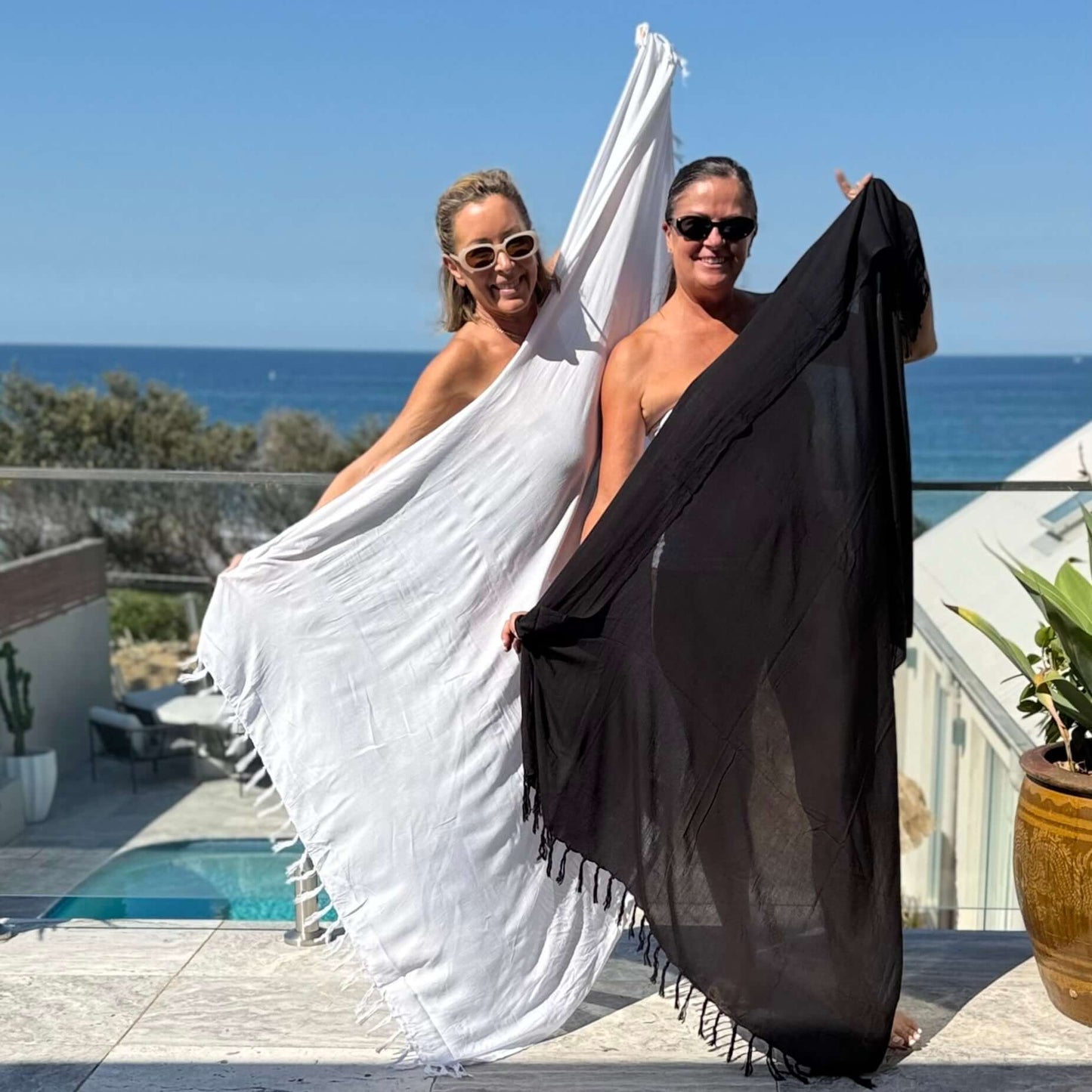 Classic black sarong worn as beach cover-up, flowing rayon fabric
