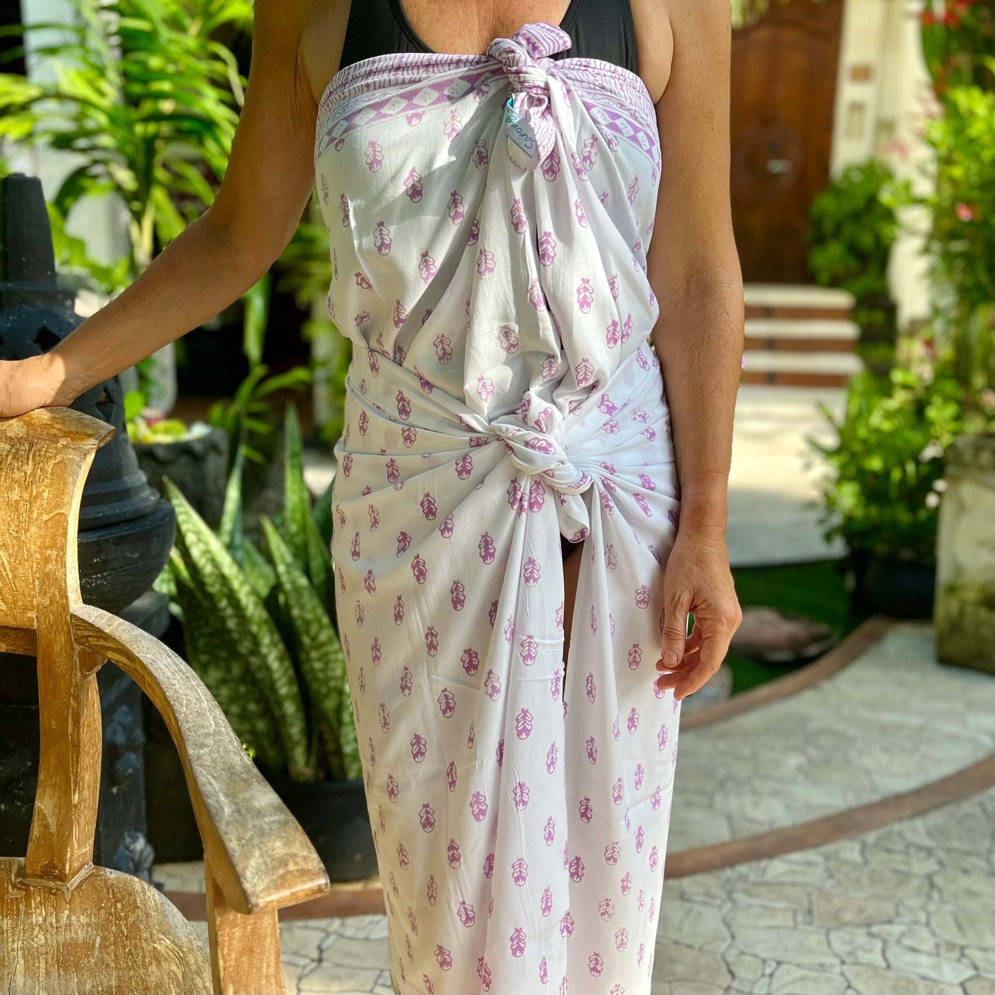 Firefly pink luxe styled on beach model wearing sarong hut design
