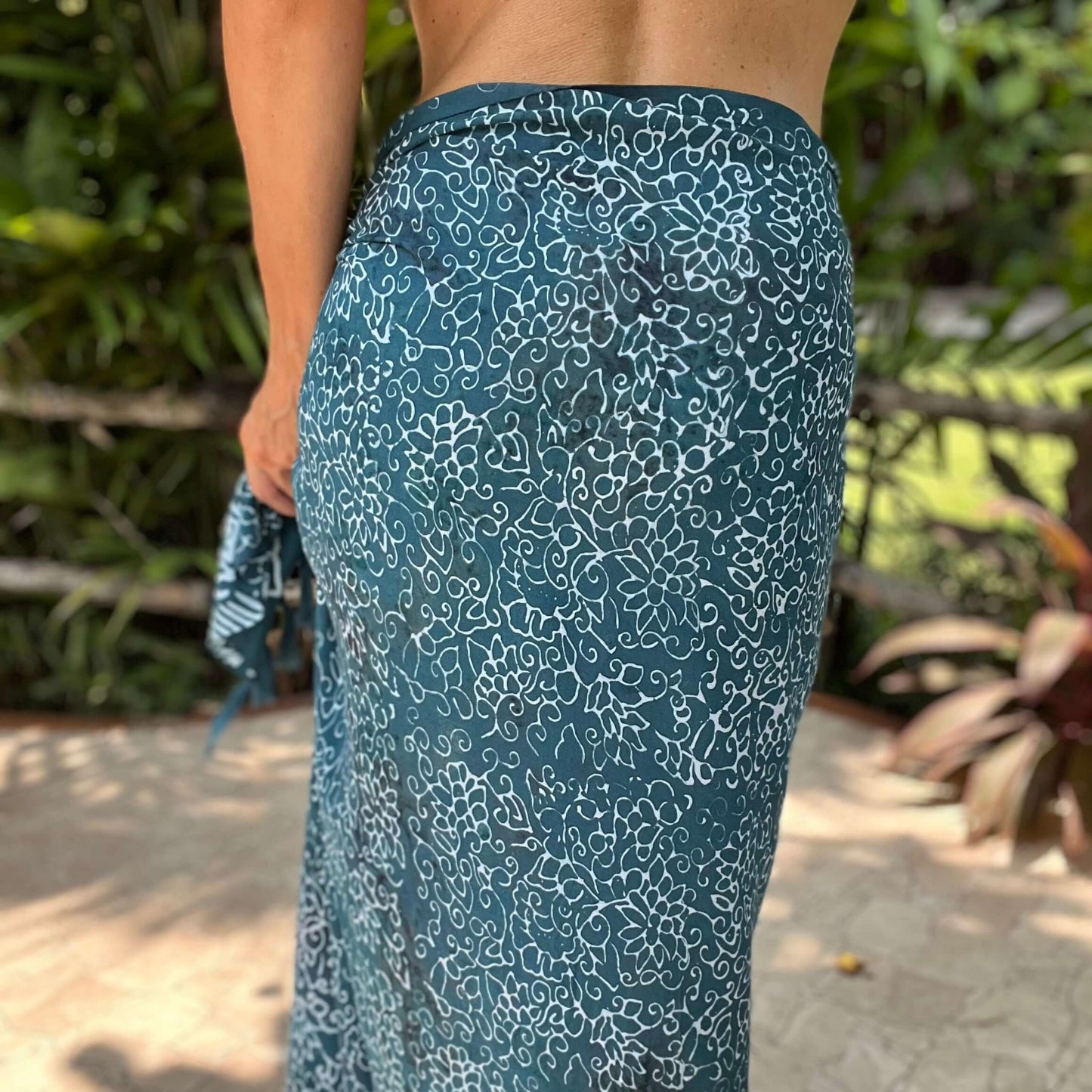 Free spirit teal beach sarong beachwear look, photographed outdoors in natural light