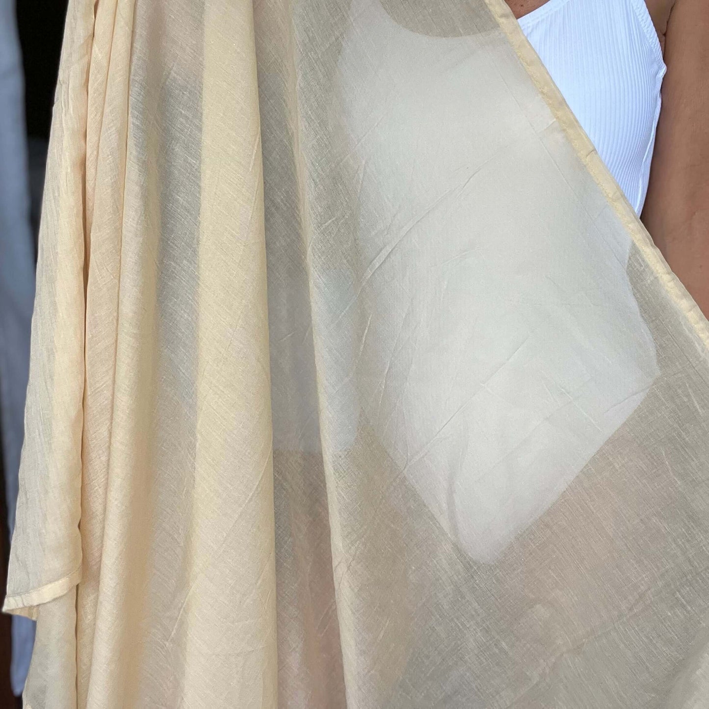 Golden sand cotton sarong styled on beach model wearing sarong hut design