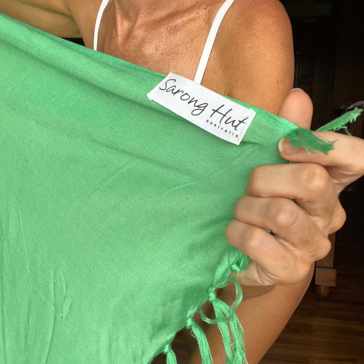 Green pop beach sarong worn as beach cover-up, flowing rayon fabric