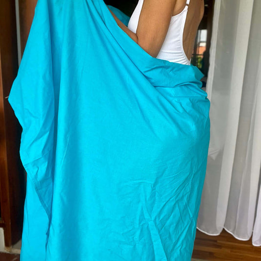 Island blue cotton sarong worn as beach cover-up, flowing rayon fabric