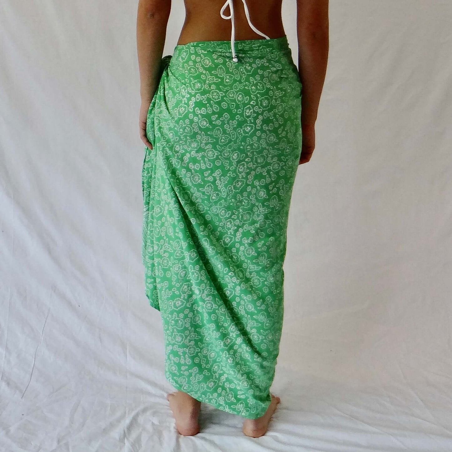 Mariana luxe sarong styled on beach model wearing sarong hut design