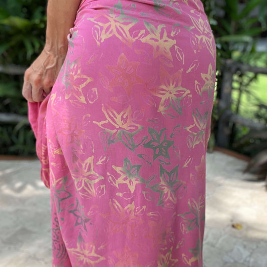 Pareo coral luxe sarong beachwear look, photographed outdoors in natural light