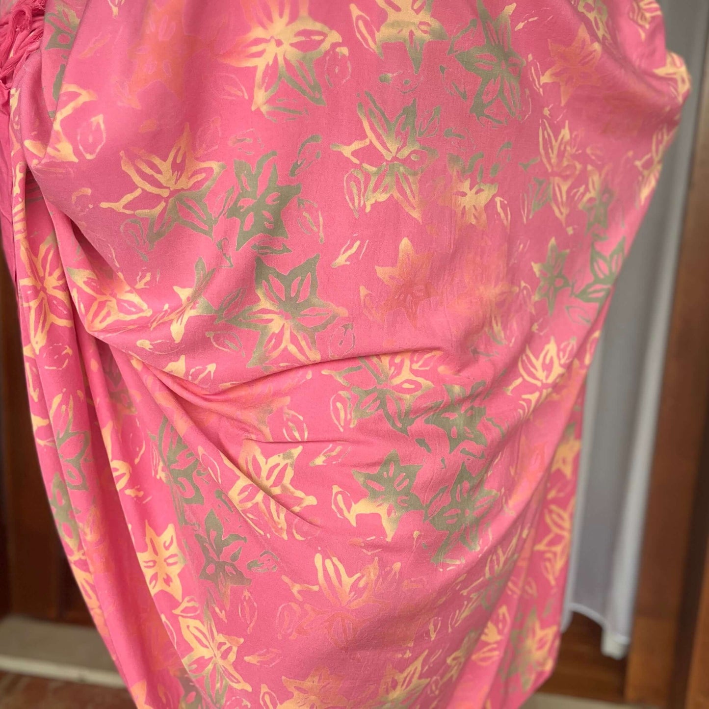 Pareo coral luxe sarong worn as beach cover-up, flowing rayon fabric