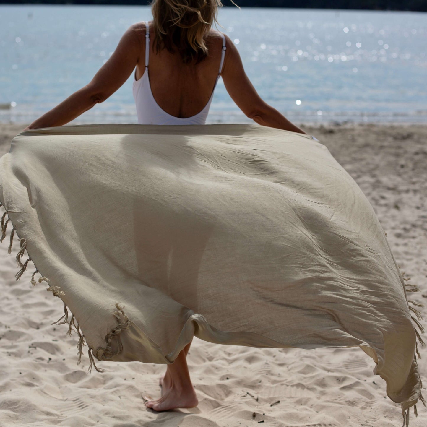 Sand beach sarong styled on beach model wearing sarong hut design