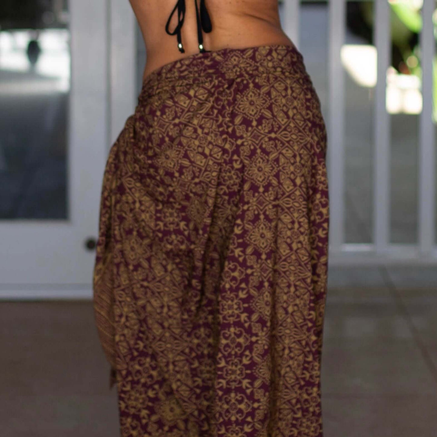 Traditional women luxe sarong beachwear look, photographed outdoors in natural light