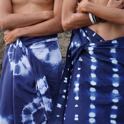 Reef cotton mens sarong styled on beach model wearing sarong hut design