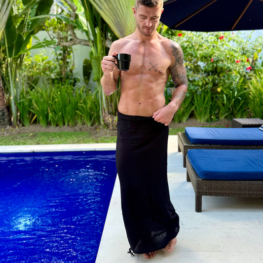 Man by the pool in bali wearing a classic black beach wraps-sarong
