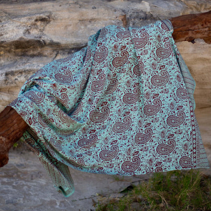 Green earth luxe sarong worn as beach cover-up, flowing rayon fabric