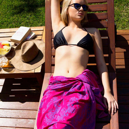 Bright bubbly luxe styled on beach model wearing sarong hut design