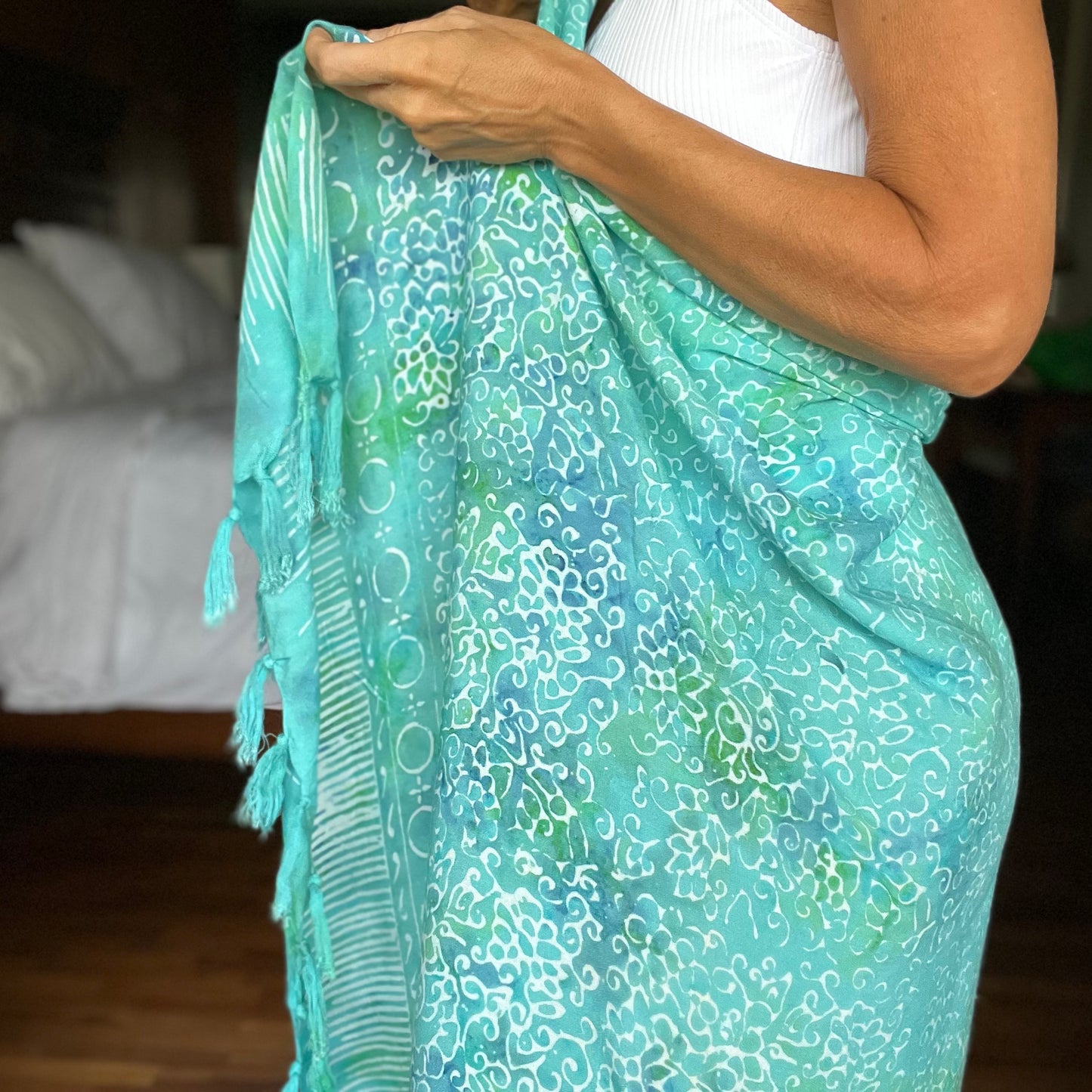 Free spirit aqua beach sarong styled on beach model wearing sarong hut design