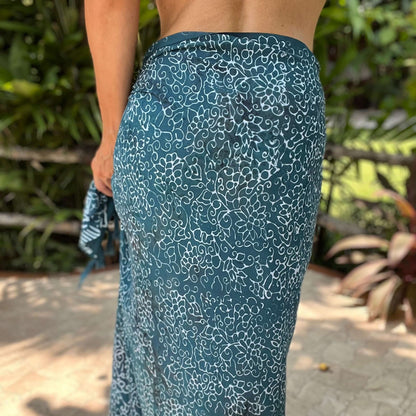 Free spirit teal beach sarong beachwear look, photographed outdoors in natural light