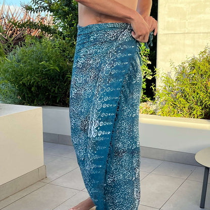 Free spirit teal mens beach sarong beachwear look, photographed outdoors in natural light