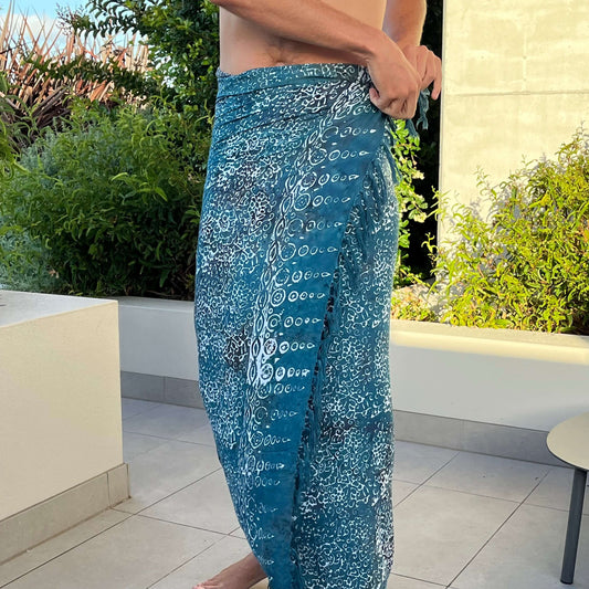 Free spirit teal mens beach sarong beachwear look, photographed outdoors in natural light