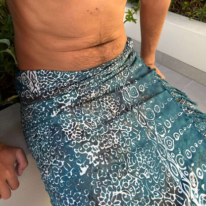 Free spirit teal mens beach sarong worn as beach cover-up, flowing rayon fabric