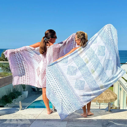 Freedom blue voile sarong styled on beach model wearing sarong hut design