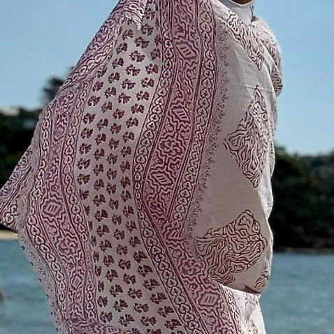 Freedom pink voile sarong styled on beach model wearing sarong hut design