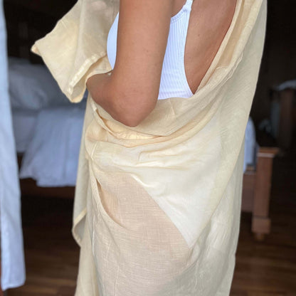 Golden sand cotton sarong worn as beach cover-up, flowing rayon fabric