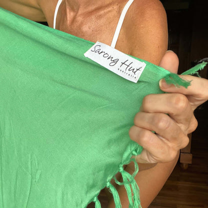 Green pop beach sarong worn as beach cover-up, flowing rayon fabric