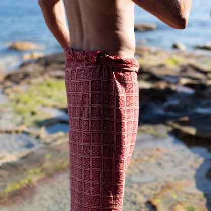 Liberation luxe men sarong beachwear look, photographed outdoors in natural light
