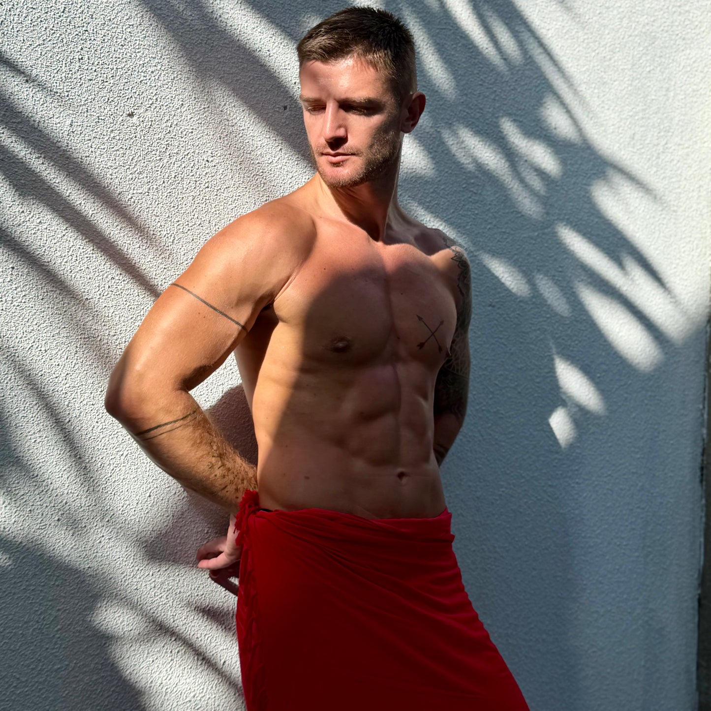 man wearing a red sarong hut brand sarong in bali