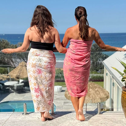 Pareo coral luxe sarong beachwear look, photographed outdoors in natural light