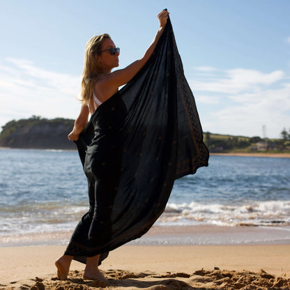 retreat womens black and gold sarong beach side shot