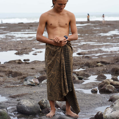 spear fishing mens luxe sarong man on beach checking his watch