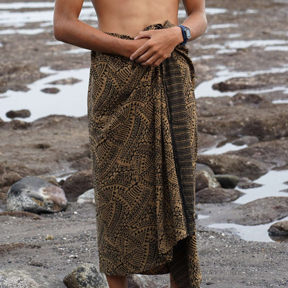 Spear fishing men luxe sarong styled on beach model wearing sarong hut design