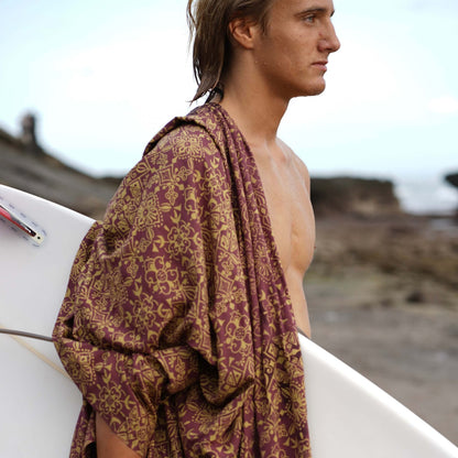 Traditional men luxe sarong beachwear look, photographed outdoors in natural light