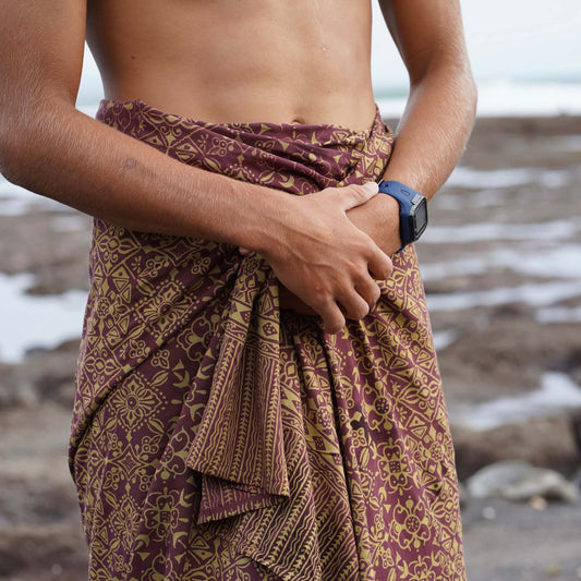 Traditional men luxe sarong styled on beach model wearing sarong hut design